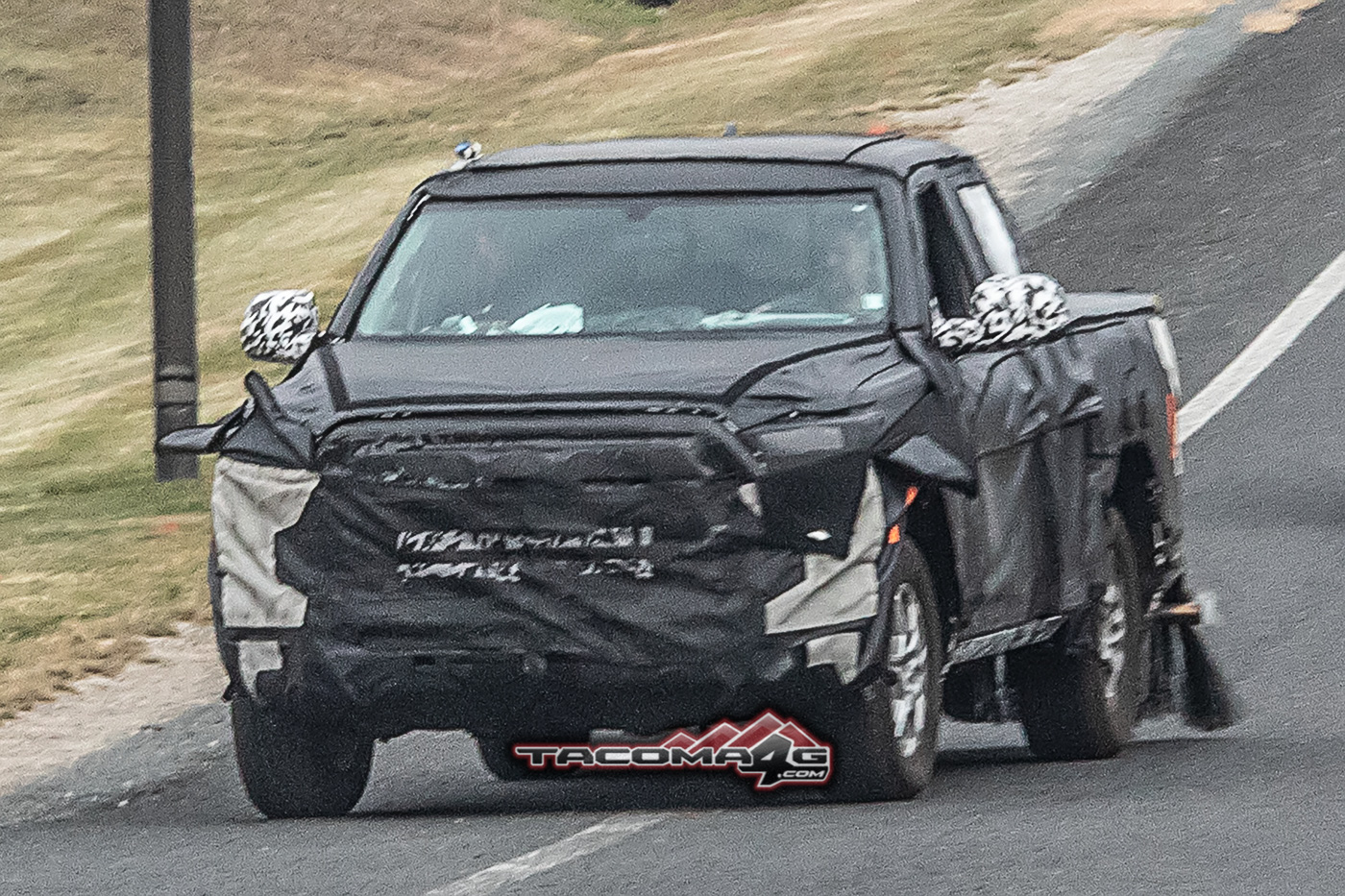 2024 Tacoma Spied: 2024 Toyota Tacoma Mule Reveals Partial Headlights, Grille and Hybrid Clues 2024-toyota-tacoma-front-fascia-slip-hybrid-clues-1