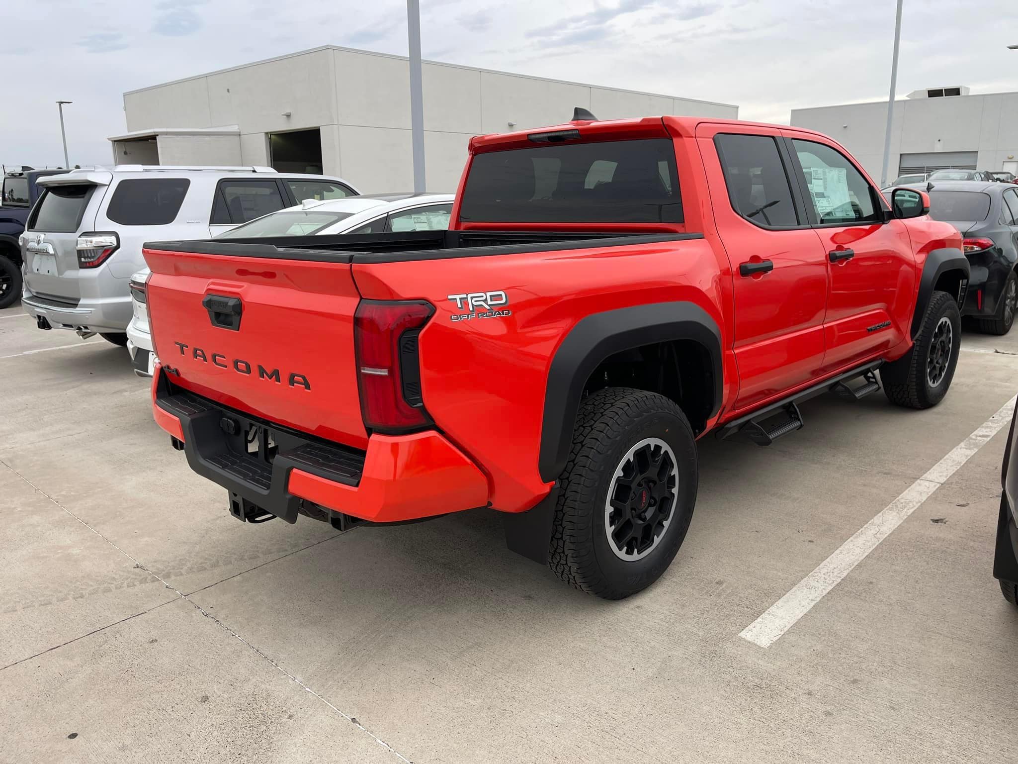 2024 Tacoma Updates of 2024 Tacomas on dealer lots (dealership, pricing, photos) Solar Octane 2024 Tacoma TRD Off-Road interior & exterior at dealership 8